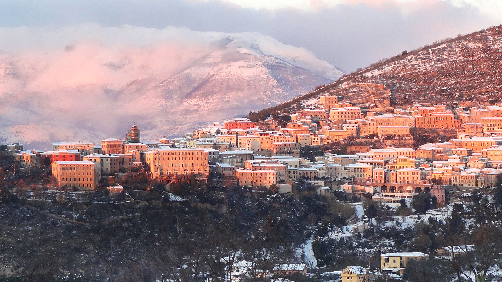 Snow-covered village at sunset