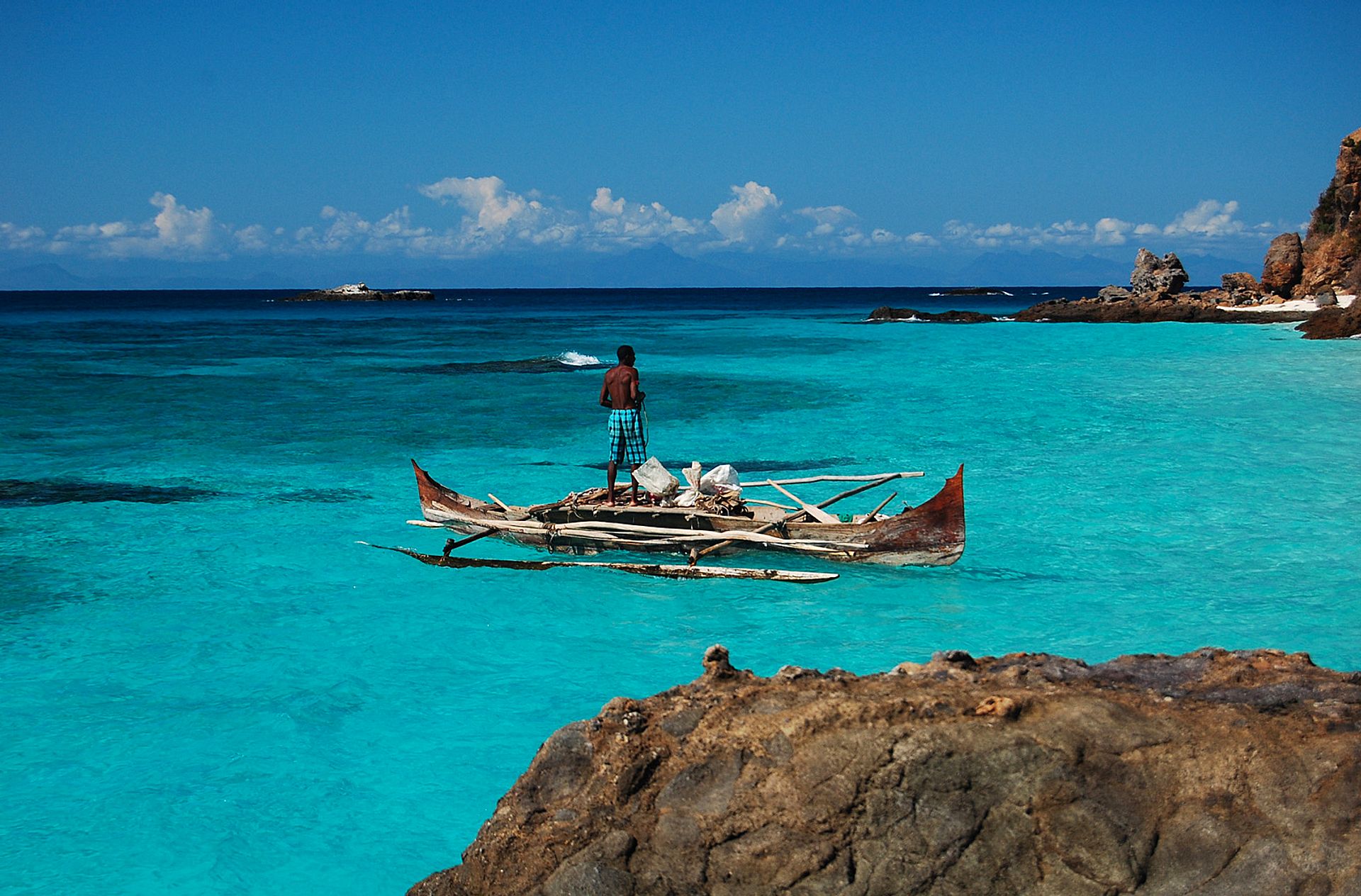 Fisherman in the turquoise sea