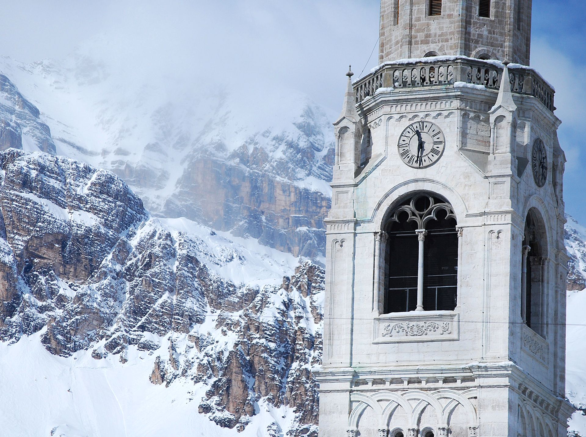 Bell tower among the mountains of Cortina D'Ampezzo