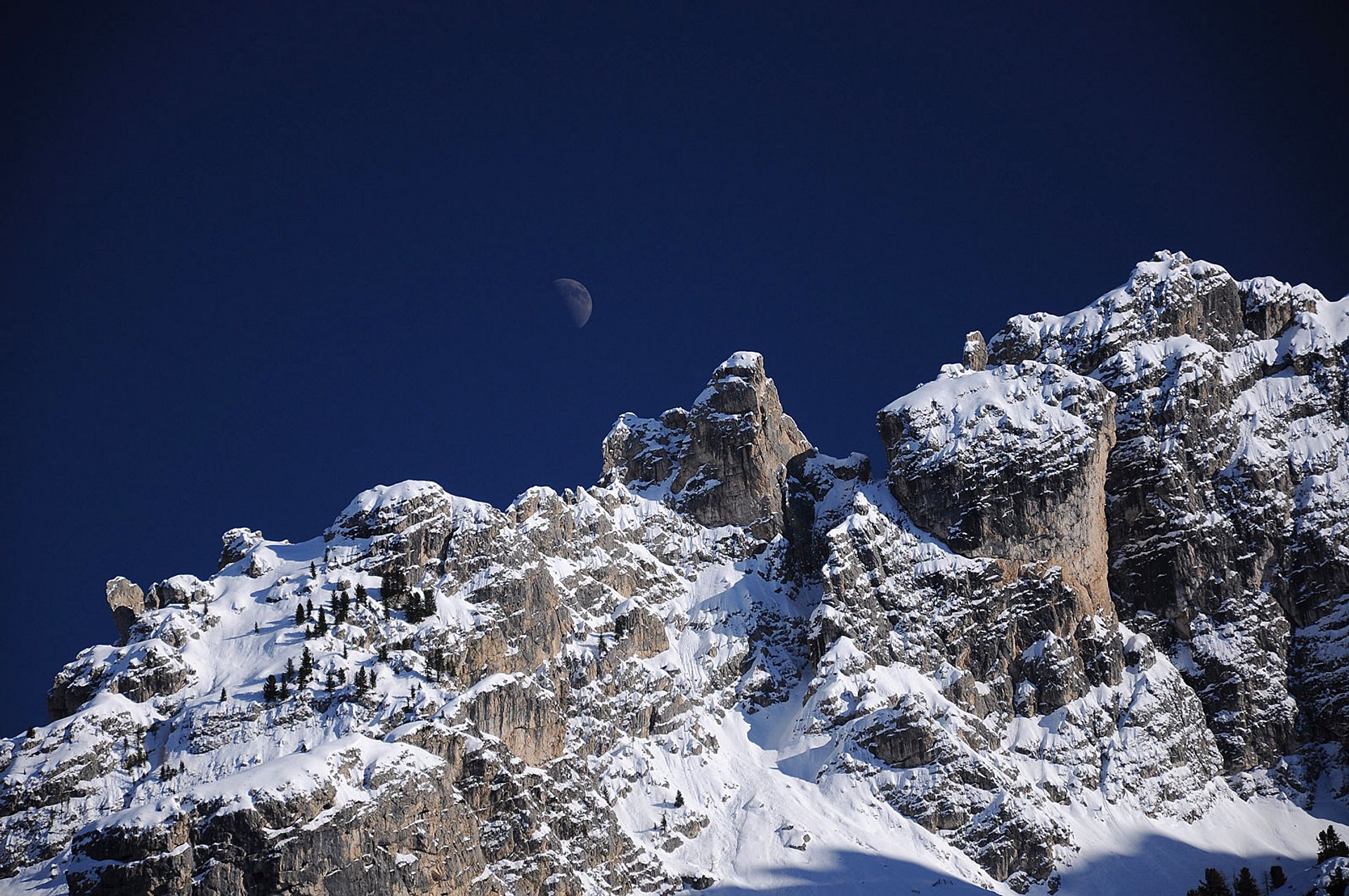 Snow-capped peaks with moon