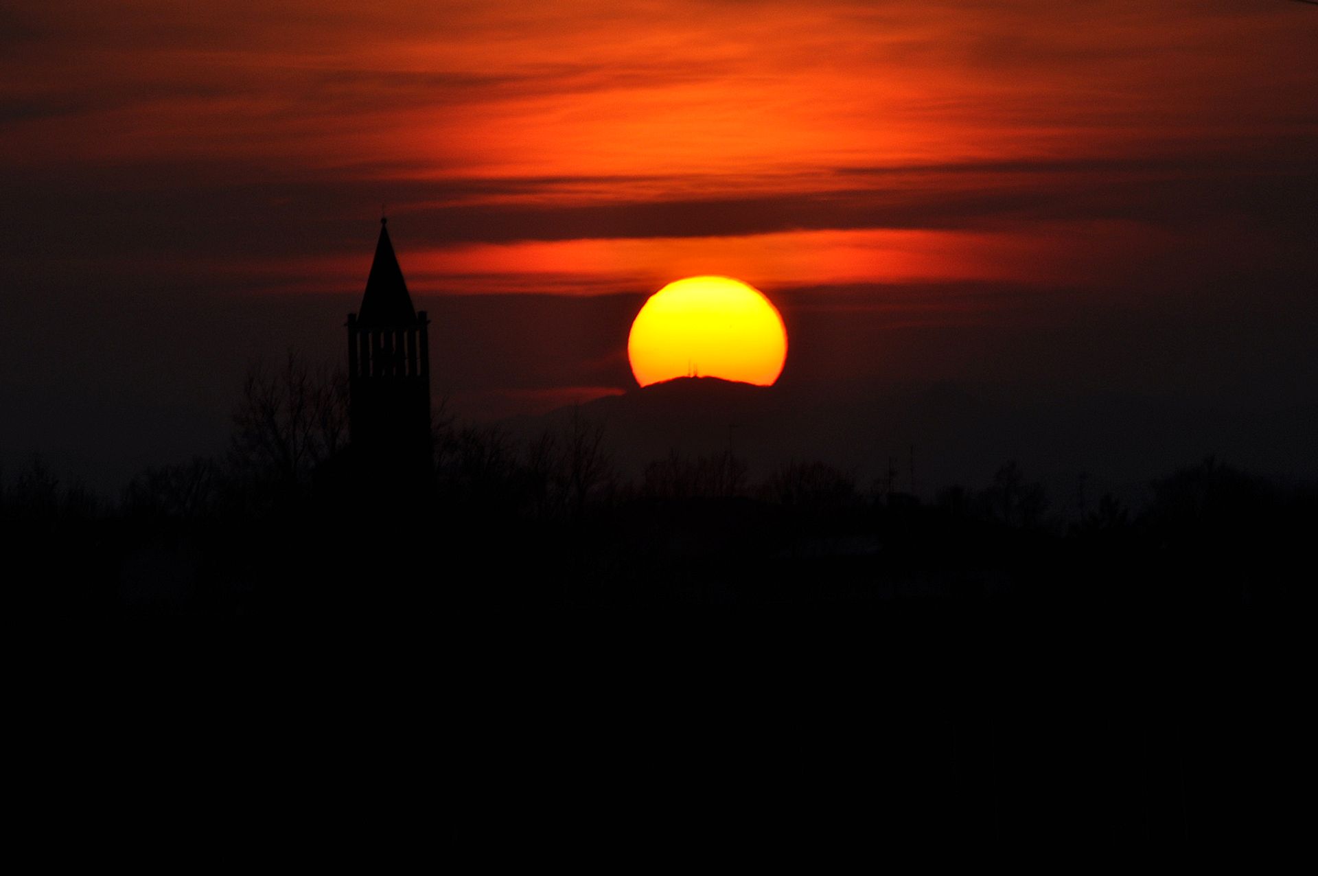 Sunset with the silhouette of a bell tower