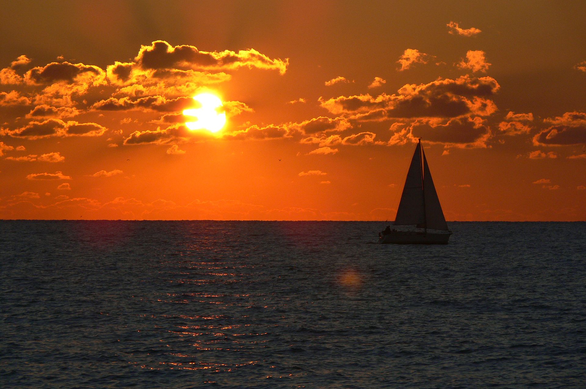 Golden sunset with boat at Fiumicino sea